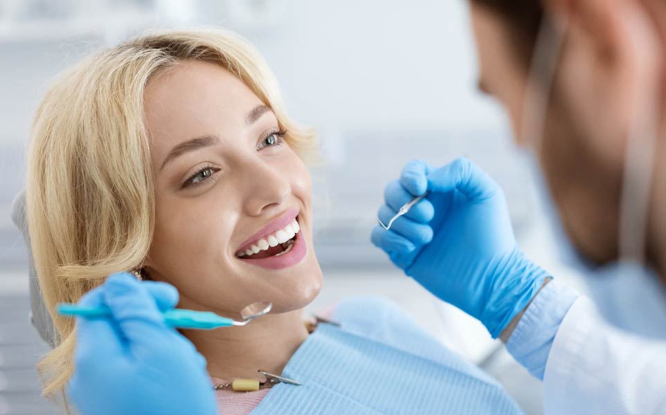 female-dental-patient-smiling-during-dental-exam