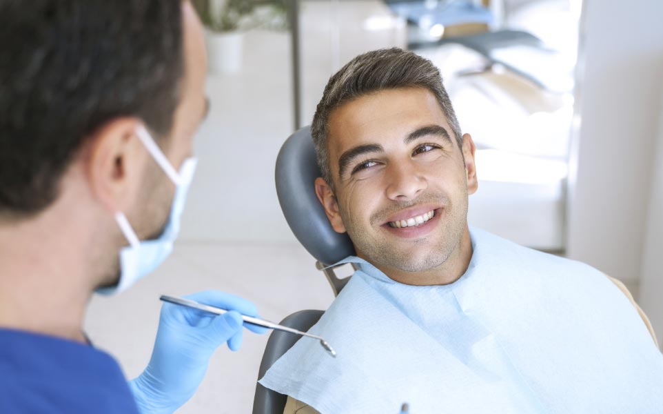 male-dental-patient-smiling-during-dental-exam